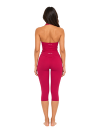 Back view of a model wearing the Ninety Nine Berry Blush set, featuring a berry-colored V-neck top and leggings.