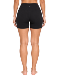Ninety Nine black Sculpt Shorts with a high-rise waistband and V-shaped back seam, worn by a model from behind.