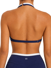 Back view of Ninety Nine Ocean Edge Set featuring a navy and white color-blocked halter bra and high-rise bottoms.