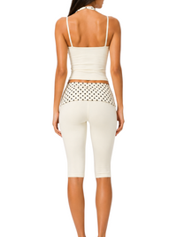 Ninety Nine Butter Dot set featuring a butter-coloured halter top and capri leggings with black polka-dot trim.