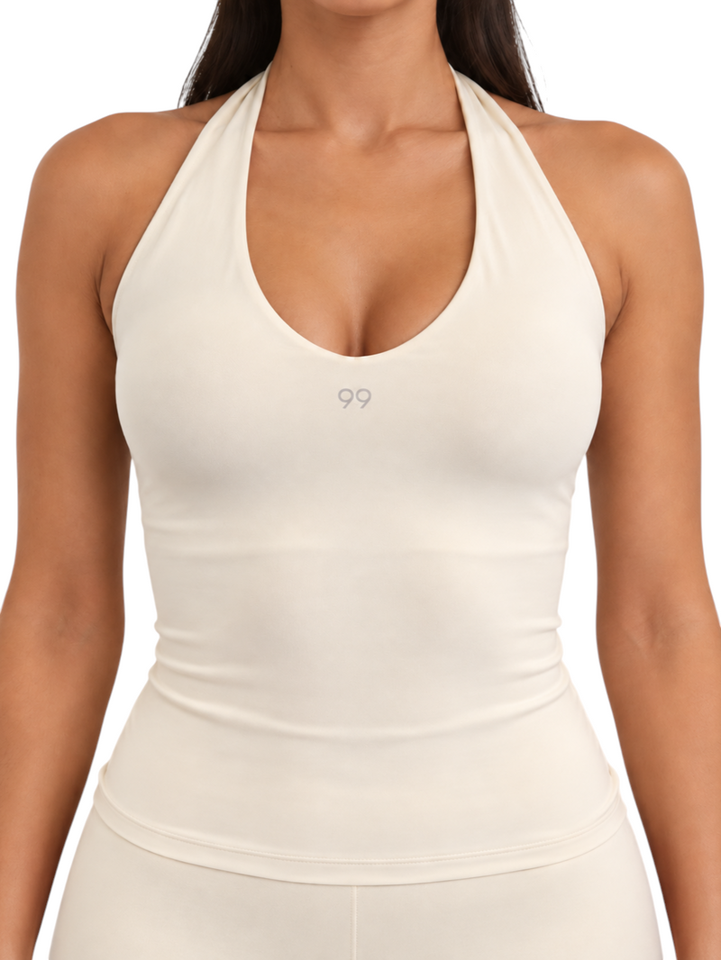 Ninety Nine vanilla halter top with a deep scoop neckline and fitted silhouette in breathable stretch nylon fabric.