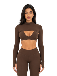 Model wearing a Ninety Nine cocoa brown cutout long sleeve crop top and matching high-waisted leggings set.
