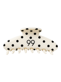 Ninety Nine hair claw clip in cream with black polka dots and a central 99 logo, featuring a strong grip design.