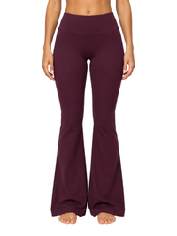 Ninety Nine high-waisted dark purple flare leggings made of stretchy nylon-spandex fabric on a model.