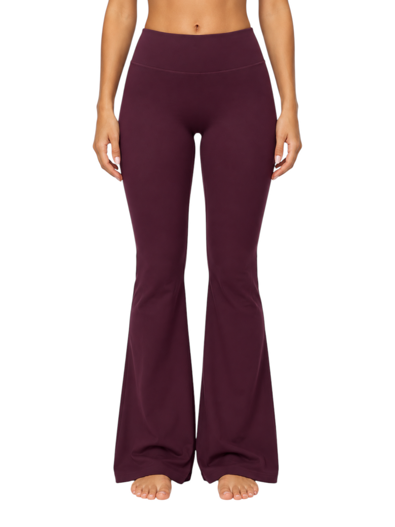 Ninety Nine high-waisted dark purple flare leggings made of stretchy nylon-spandex fabric on a model.