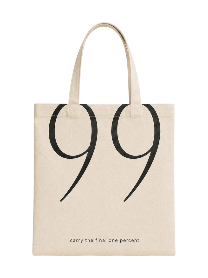 Ninety Nine beige canvas tote bag with large black 99 graphic and carry the final one percent text